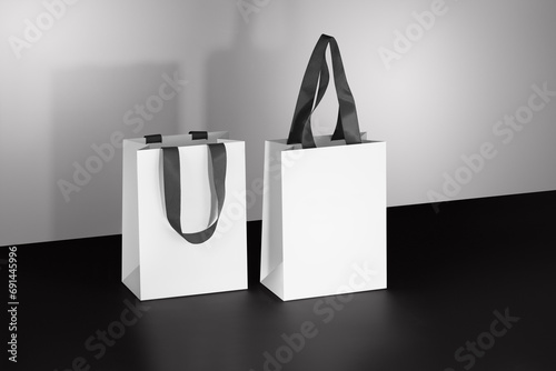Mockup of a white paper bag with gray fabric handles