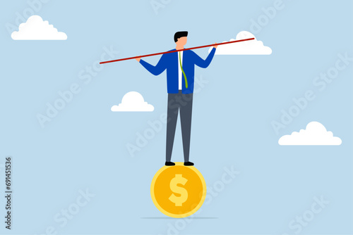 Financial and business risk, businessman balanced not to fall off the golden coin.