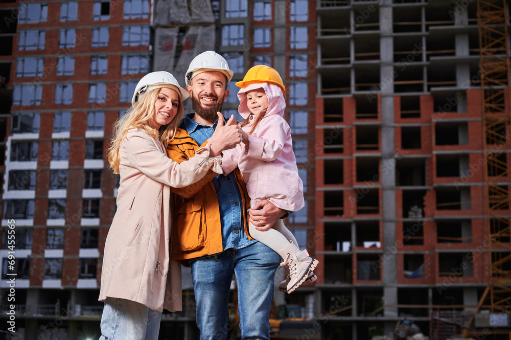 Contruction Project Parents Parents and daughter showing approval gesture and smiling while ...