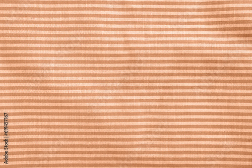 Peach fuzz striped cotton texture. Fabric textile background.
