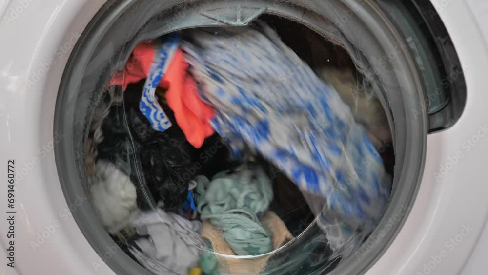 Close-up of washing machine in the process, wash clothes in the washing machine. Close-up of washing machine in the process, wash clothes in the washing machine.