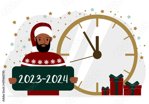 5 minutes for the new year. A man holds a poster with the text 2023-2024.