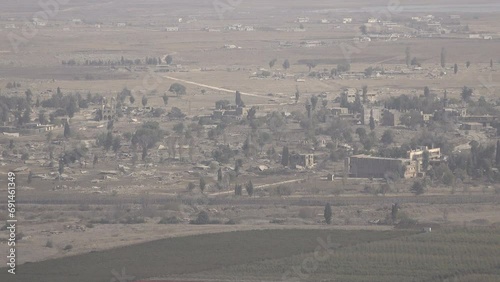 View of the Israel - Syria border, with destroyed and collapsed buildings on the Syrian side
 photo