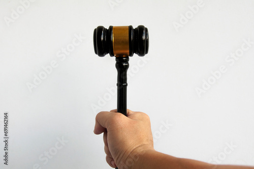 Hand holding Gavel with white background. Law concept