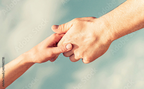 Lending a helping hand. Hands of man and woman reaching to each other, support. Solidarity, compassion, and charity, rescue