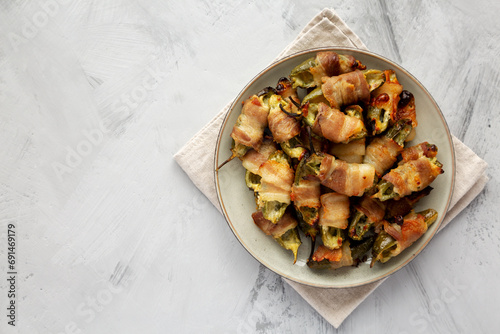 Homemade Bacon-Wrapped Jalapeno Poppers on a Plate, top view. Space for text. photo