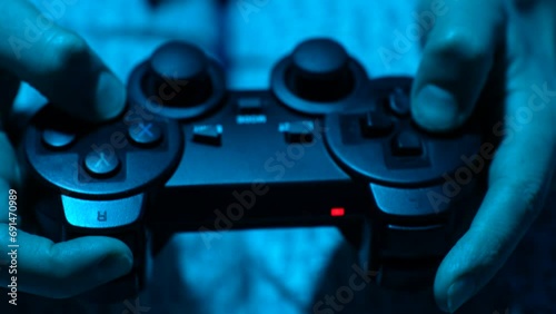 Hand playing on video game controller, close-up