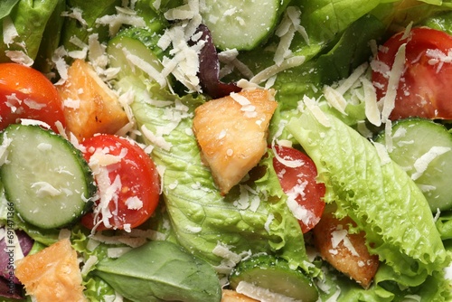 Delicious salad with chicken, cheese and vegetables as background, top view