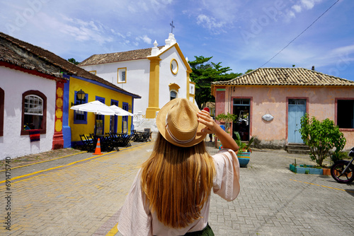 Tourism in Santa Catarina, Brazil. Young traveler woman visiting Santo Antônio de Lisboa historic district of the city of Florianopolis in Santa Catarina state, Brazil. photo