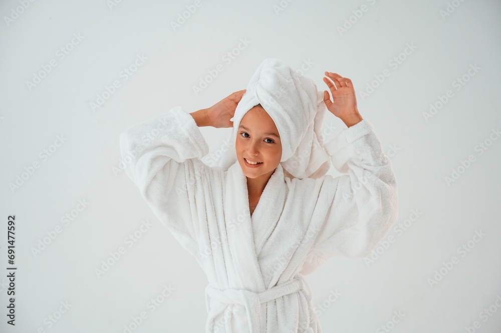 With towel on the head. Conception of beauty and self care. Young girl is in the studio With towel on the head. Conception of beauty and self care. Young girl is in the studio