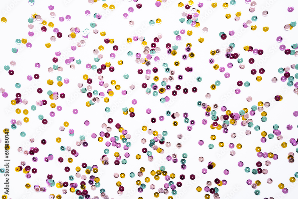 Various colored sequins on a white background.