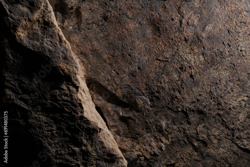 Brown stone texture, dark abstract background. Natural mineral rock close up details, empty backdrop with copy space for design