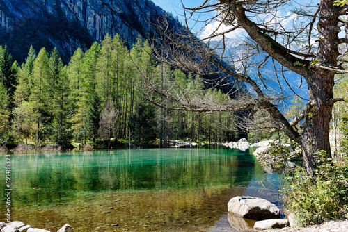 Alpine landscape on the stream and the small lake flowing in the Val di Mello in Valtellina Sondrio Italy