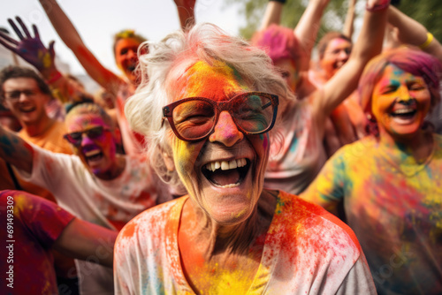 Group of happy senior people with colorful faces in party outdoors.