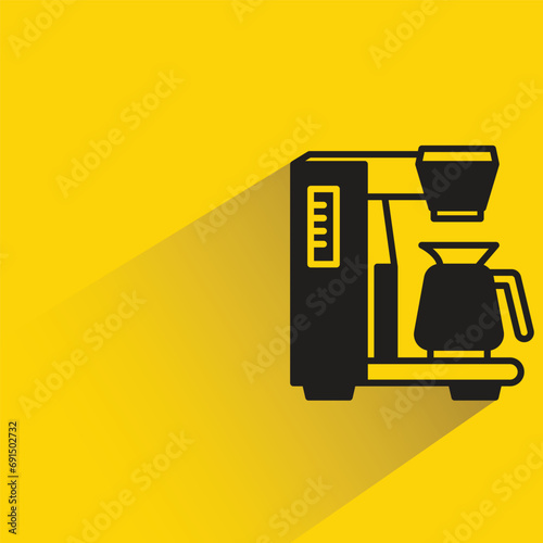 coffee machine with shadow on yellow background