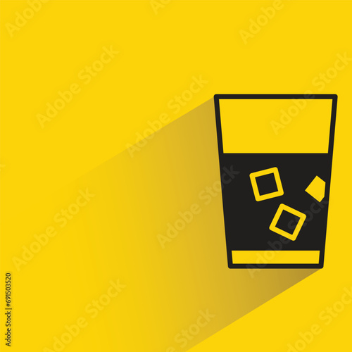 water glass with shadow on yellow background