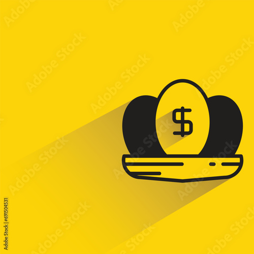 dividend egg on nest with shadow on yellow background