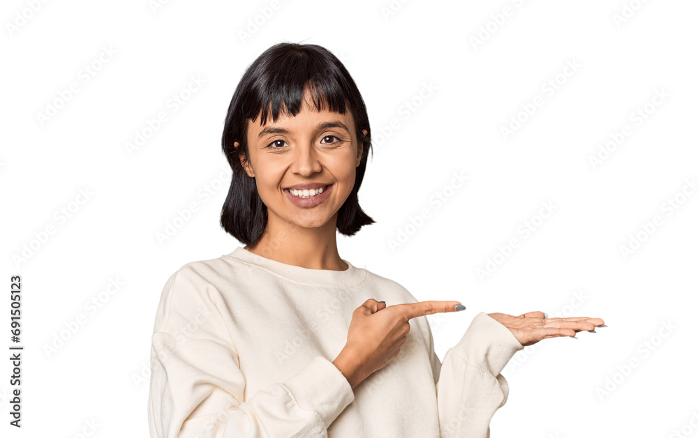Young Hispanic woman with short black hair in studio excited holding a copy space on palm. Young Hispanic woman with short black hair in studio excited holding a copy space on palm.