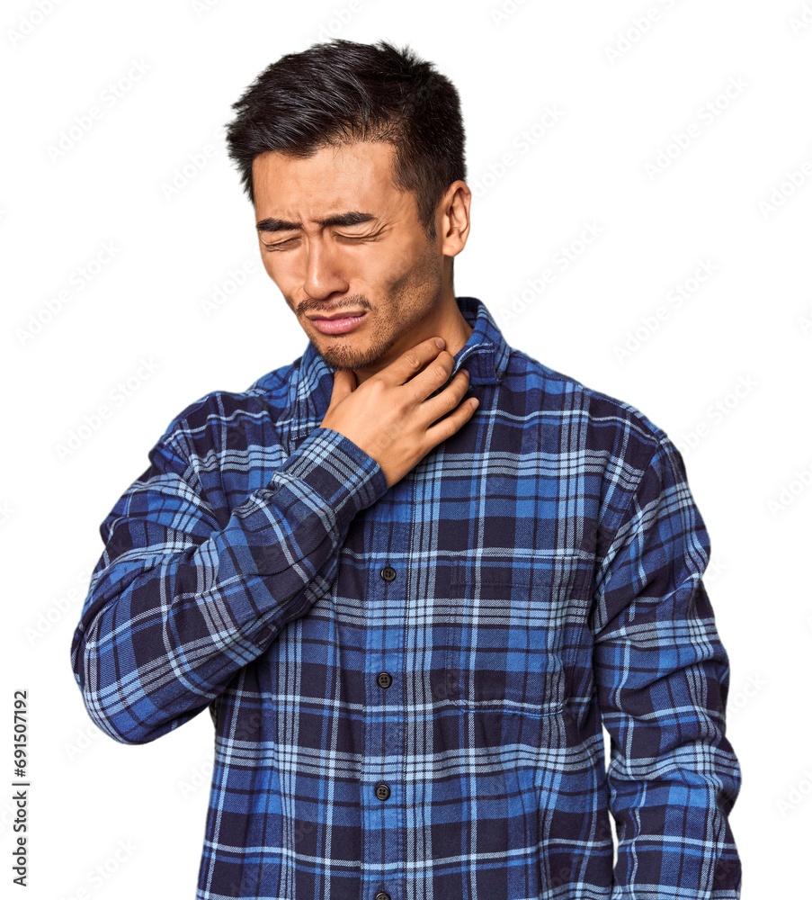 Young Chinese man in studio background suffers pain in throat due a virus or infection.