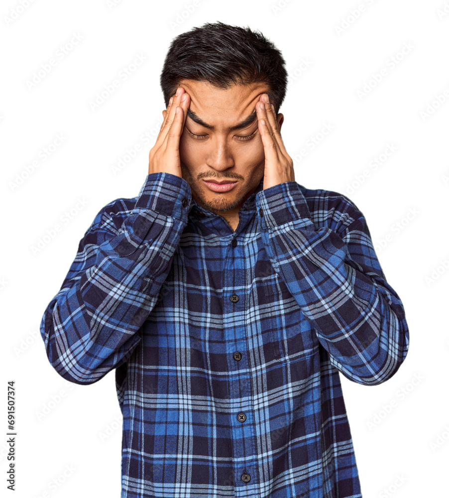 Young Chinese man in studio background touching temples and having headache. Young Chinese man in studio background touching temples and having headache.