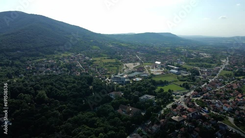 Aerial view of town Arandjelovac in a shadow surrounded by mountains and woods photo