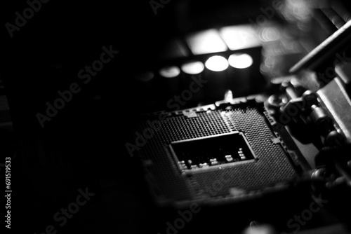 closeup of computer mainboard, electronic circuit board, processor board in computer. black and white lighting. blurred background photo