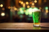Patrick Day green beer on empty wooden table top and blurred green background in pub. Festive traditional beverage.