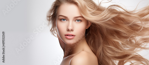 Portrait closeup young beautiful woman model with long blonde hair on a white background. 
