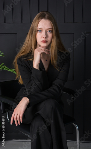 Obraz na płótnie Young beautiful woman, fashion model, in a black suit in the studio w salonie