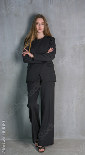 Obraz na płótnie Young beautiful woman, fashion model, in a black suit in the studio w salonie
