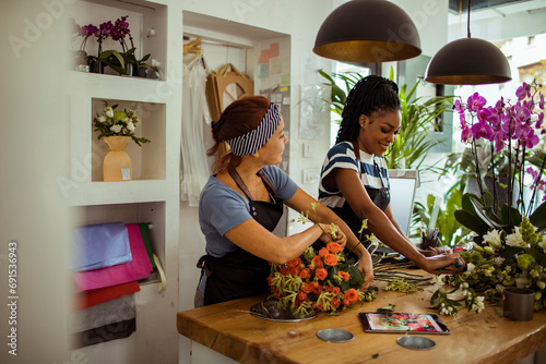 Young female florist working on bouquet in flowershop