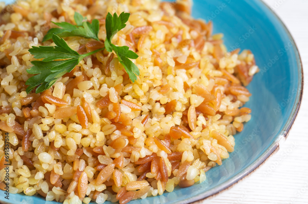 Traditional delicious Turkish food, bulgur pilaf with vermicelli (Turkish name; arpa sehriyeli bulgur pilavi) Traditional delicious Turkish food, bulgur pilaf with vermicelli (Turkish name; arpa sehriyeli bulgur pilavi)