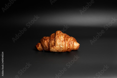 Croissant on black background