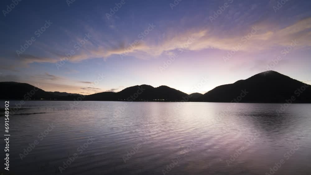 Sunrise colorful sky reflecting on surface of water and mountain Sunrise colorful sky reflecting on surface of water and mountain