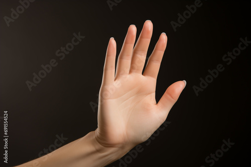 Female open hand displaying unseen item against plain backdrop
