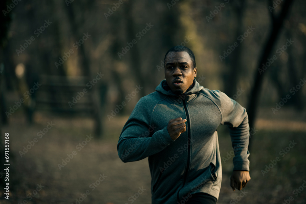 Young man running outdoor in forest