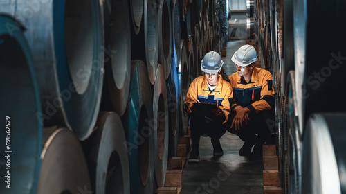 Photography Warehouse inventory management in metalwork factory with engineer conduct storage check and quality control assessment on cylinder rolled metal for civil engineering project