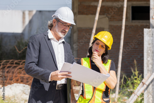 Fotografie Senior professional architect consulting meeting talking with construction engineer women project manager review planing with floor plan design blueprint