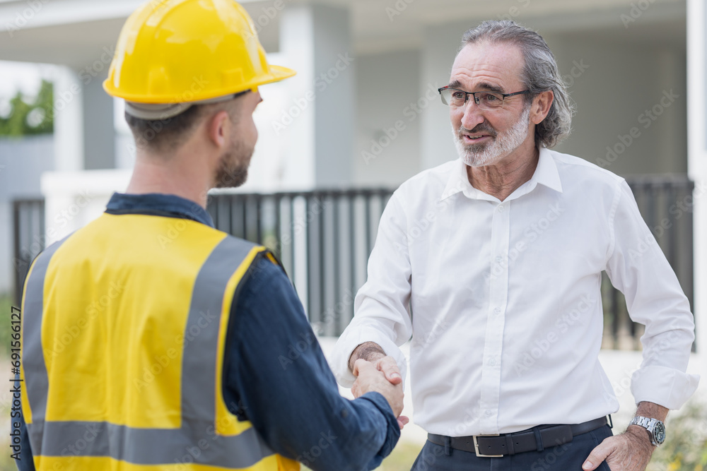 Businessman project director or real estate business owner land investor happy hand shaking with engineer foreman builder in house construction site. Businessman project director or real estate business owner land investor happy hand shaking with engineer foreman builder in house construction site.