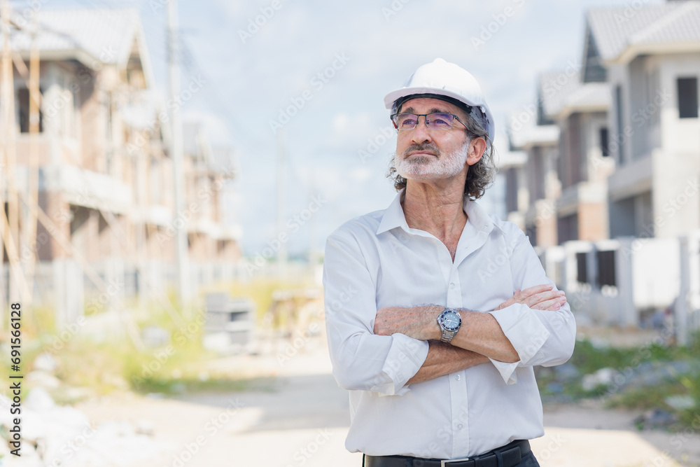 Portrait senior male business man land development investor standing confident in under construction site. Professional real estate project manager man arm folded Portrait senior male business man land development investor standing confident in under construction site. Professional real estate project manager man arm folded