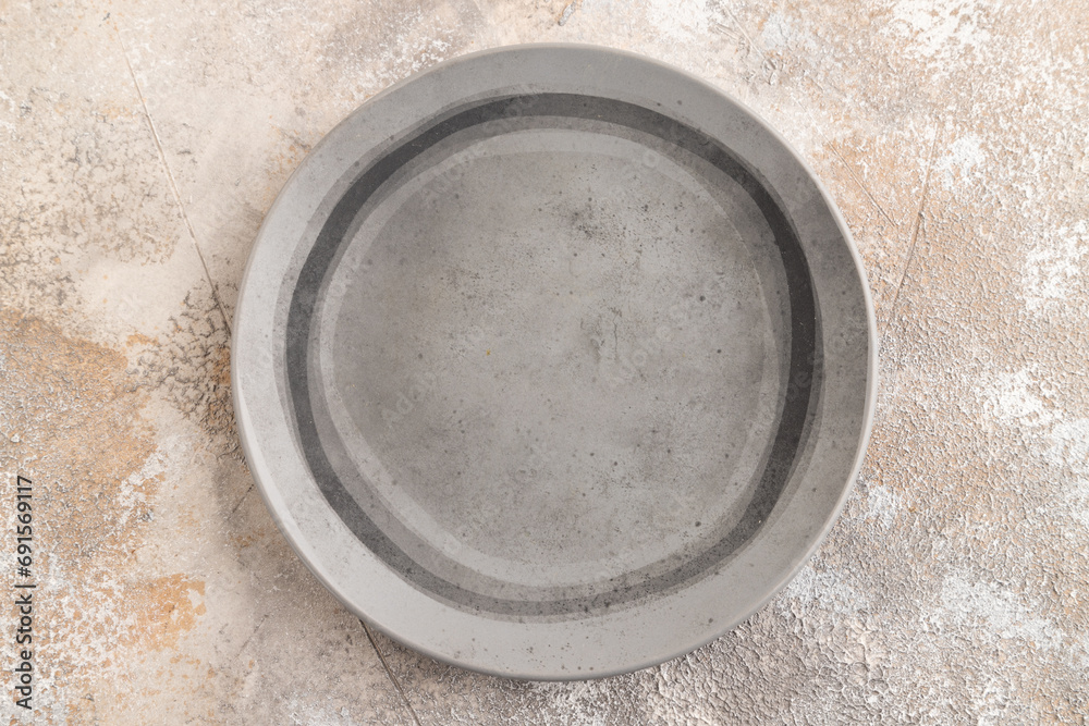 Empty gray ceramic plate on gray concrete background. Top view, copy space Empty gray ceramic plate on gray concrete background. Top view, copy space