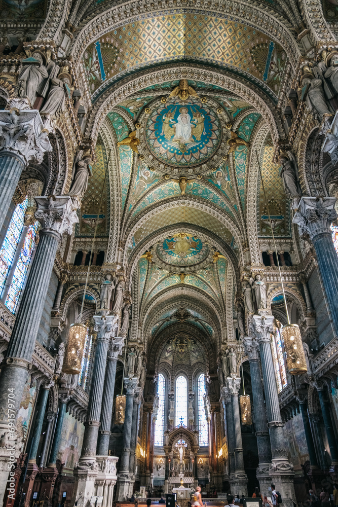View of the arches, ceiling, and mosaics of the nave of the Basilica of Notre-Dame de Fourvière, with its Neo-Byzantine architecture in Lyon (France)