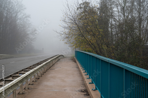Empty foodbridge crossing the highway on a foggy morning, Dilbeek, Belgium © Werner