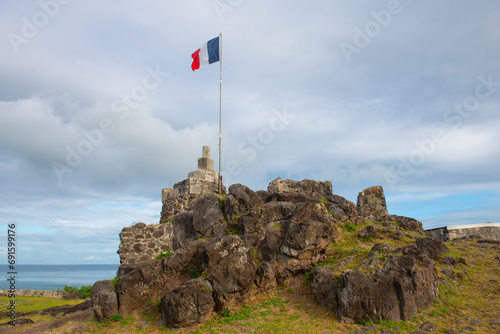 France National Flag flying on Fort St. Louis in historic Marigot, French Collectivity of Saint Martin.  photo