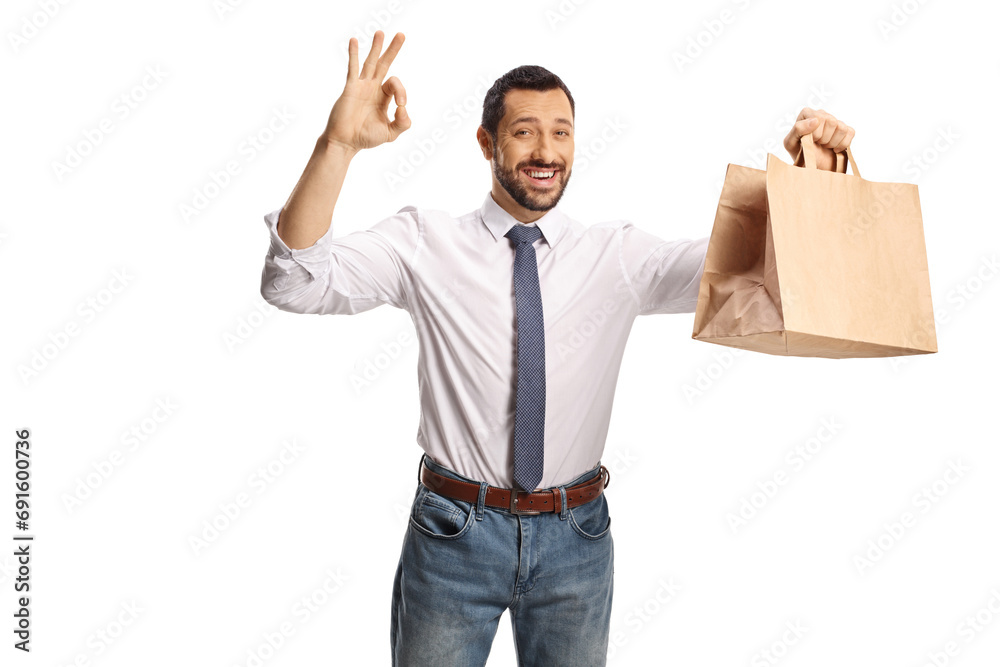Businessman gesturing ok sign and holding a paper bag Businessman gesturing ok sign and holding a paper bag