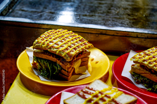 delicious Chicken Sandwich and Burger Making by Chef. Street Food in Colombo. photo