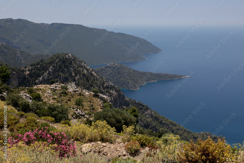 A coastal landscape of Mediterranean sea at Kalabantia. Amazing seascape of Lycian way: high rock cliffs, mountain ridge, rugged shoreline, blue lagoon. Fascinating hiking journey of south Turkey. 