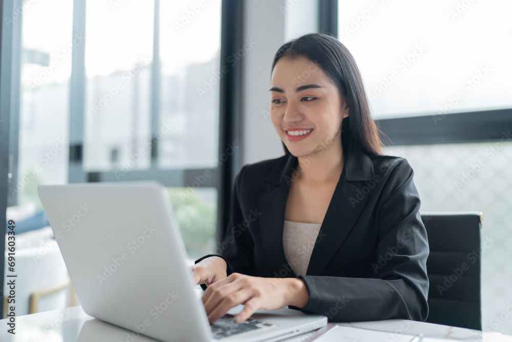 Beautiful confident asian business woman working with laptop Hands typing keyboard. Professional investor working new start up project. business planning in office. Technology business Beautiful confident asian business woman working with laptop Hands typing keyboard. Professional investor working new start up project. business planning in office. Technology business