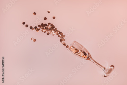 Large round sparkles fly out of a glass against a pink background.