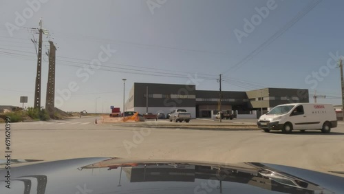 First person view, FPV, from dashcam of car driving on an industrial site on the outskirts of Sines, Portugal. Road trip video in POV photo